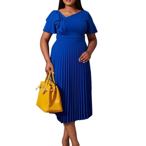 Close-up of royal blue pleated dress featuring ruffle detail on the asymmetric neckline