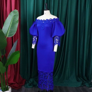 Detail of off-shoulder royal blue dress with lantern sleeves and lace patchwork