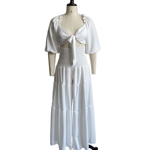 Dettaglio del completo bianco due pezzi con vita elastica arricciata su pantaloni larghi