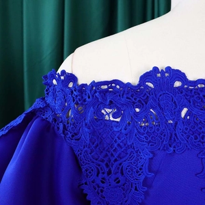 Close-up of royal blue off-shoulder dress featuring intricate hollow lace embroidery details