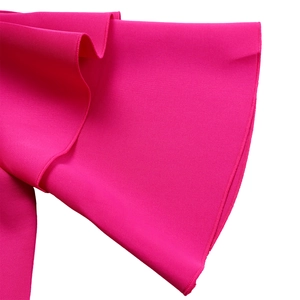 Close-up of double layered ruffle sleeves and diagonal twill fabric on rose red dress