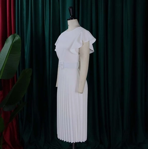 Detail of white sleeveless dress with ruffle sleeves and pleated skirt waist belt