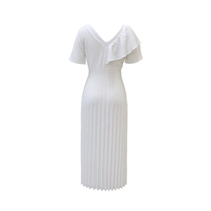 Detail view of the deep V-back design and ruffled sleeves on white pleated maxi dress