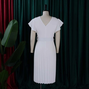 Detailed back view of white pleated dress with deep V-neck and ruffle sleeves details