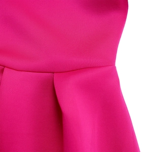 Detailed macro view of the pleated waist design on a rose pink summer dress
