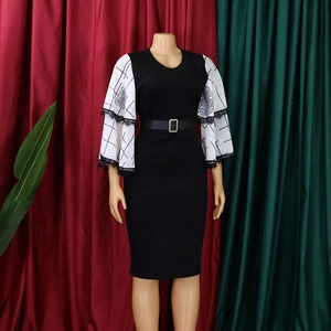Detail of elegant black pencil dress with white floral bell sleeves and lace trim