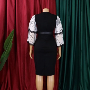 Detail of the back of a slim V-neck dress with geometric print sleeves and lace cuffs