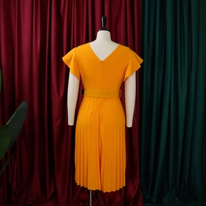Detail view of bright yellow pleated dress featuring ruffle sleeves and matching belt