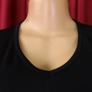 Detailed close-up of the black V-neckline and smooth stitching of the pencil dress