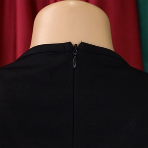 Close-up of invisible zipper and fine twill fabric on a black V-neck pencil dress