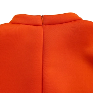 Detailed macro view of the invisible zipper and half-turtleneck on an orange dress back