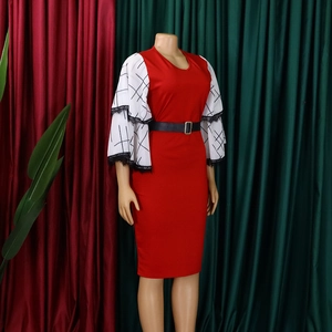 Detail of white lantern sleeves with black grid pattern and lace on a red pencil dress