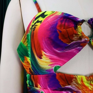 Detail of colorful abstract print dress with front cutout and side ruching design