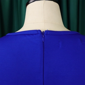Close-up of royal blue dress back with invisible zipper and textured fabric detail