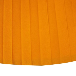 Detailed macro view of orange pleated fabric texture and vertical pleats of the summer dress