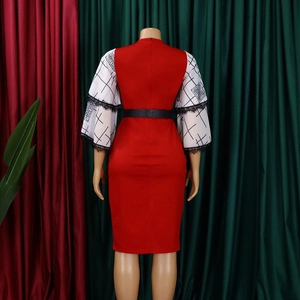 Detail of red pencil dress with flared sleeves featuring black lace and geometric patterns