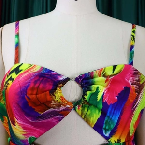 Detail of colorful feather print dress featuring a knot cutout and thin shoulder straps