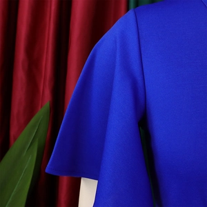 Detailed close-up of royal blue elegant flounce sleeve with high-quality knit texture