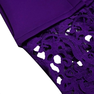 Close-up of purple lace embroidery and fabric stitching on bridesmaid gown dress