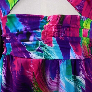 Detail of colorful abstract print fabric with fine smocked texture and reinforced stitching
