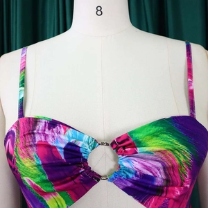 Detail of colorful abstract print dress featuring spaghetti straps and a silver metal ring