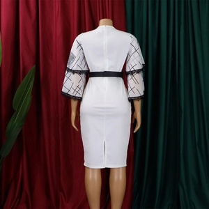 Detail view of white pencil dress back featuring slit hem and zipper closure