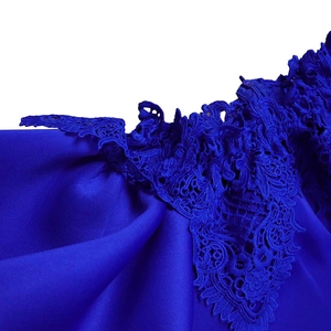 Detailed close-up of dark blue evening dress showing intricate floral lace embroidery