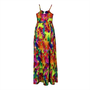 Back view of a tiered maxi dress with vibrant abstract feather print and spaghetti straps