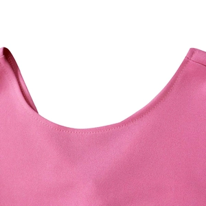 Detailed view of the round neckline and stitching on a pink pleated summer dress