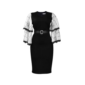 Detail of layered white flare sleeves with floral prints and lace trim on a black dress