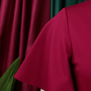 Close-up of ruffled sleeve detail on a magenta dress showing premium fabric texture