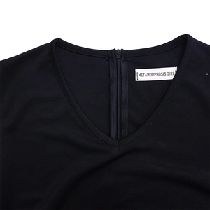 Detail of V-neckline and back invisible zipper on black pencil dress with brand label