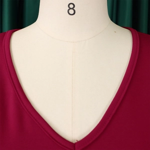 Detailed close-up of V-neckline with double-stitch edging on a wine red dress