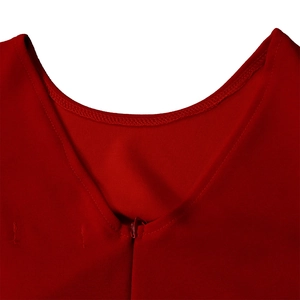 Detailed close-up of a red pleated dress with a matching concealed zipper and stitching