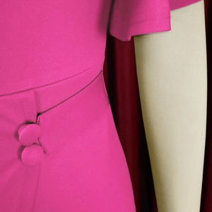 Detail of rose red dress showing fabric texture with fabric-covered buttons and fine stitching