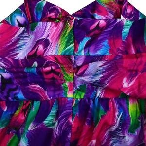 Detail of colorful abstract feather print with ruched seam on a summer maxi dress