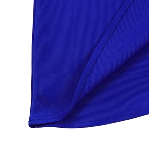 Macro detail of royal blue fabric showing twill weave texture and precise hemmed edge