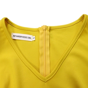 Detail of yellow V-neck dress with invisible KCC zipper and brand logo neck label