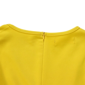 Macro shot of an invisible zipper on a bright yellow round neck dress back