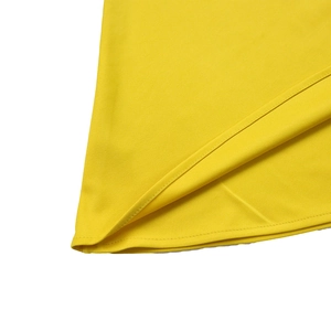 Macro detail of high-quality double-stitch hem on a vibrant yellow summer dress fabric