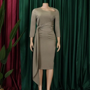 Detail of khaki long sleeve dress featuring asymmetric cutout neckline and pleated waist tie