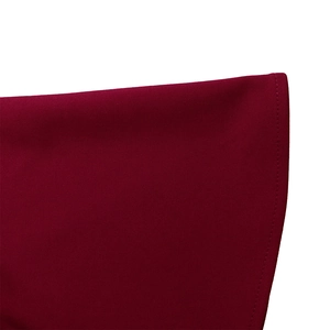Detail view of burgundy knitted fabric texture with fine flat-seam stitching craftsmanship