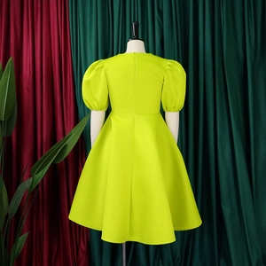 Détail des manches bouffantes et taille ajustée d'une robe évasée vert citronnée