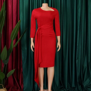 Detail view of red bodycon dress featuring asymmetric cutout neckline and ruched waist tie