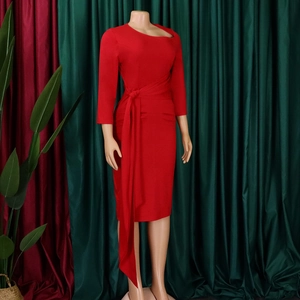 Detail of red slim fit dress with asymmetric neckline and long waist tie feature