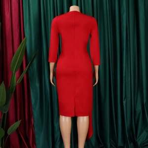 Detail view of the back of a red bodycon dress featuring hidden zipper and elegant back slit
