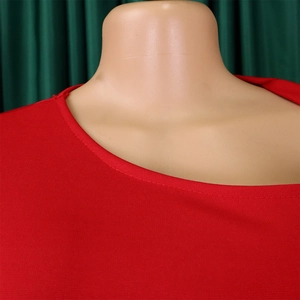 Close-up of red off-shoulder neckline showing detailed double-needle stitching on stretch fabric