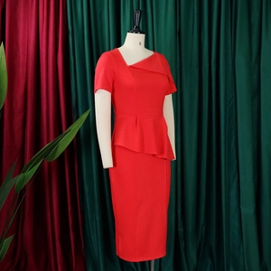Detail of red business dress featuring asymmetric neck and waist peplum frill detail