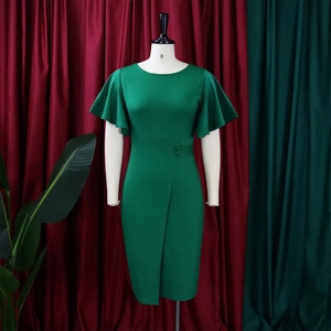Detail of dark green dress showing ruffled bell sleeves and buttoned waist pleats