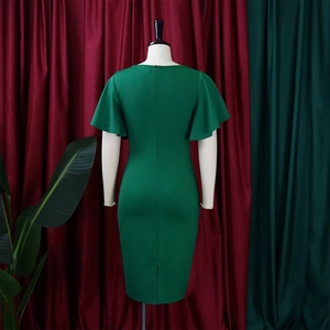 Close-up of the ruffled sleeves and back slit detail on a green bodycon dress